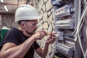 male-electrician-works-switchboard-with-electrical-connecting-cable (1)